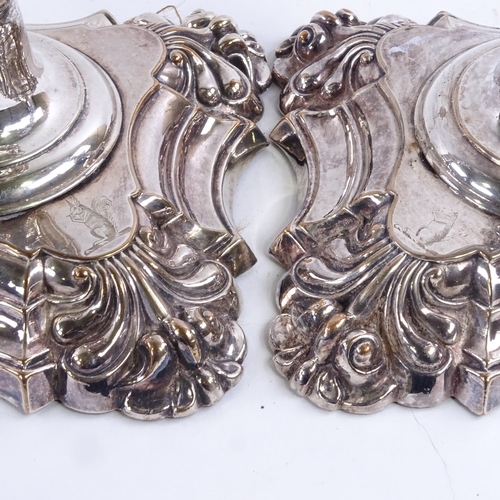 97 - A pair of 19th century silver plated candlesticks, square bases with squirrel armorial crests, heigh... 