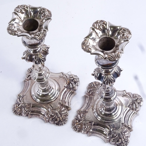 97 - A pair of 19th century silver plated candlesticks, square bases with squirrel armorial crests, heigh... 