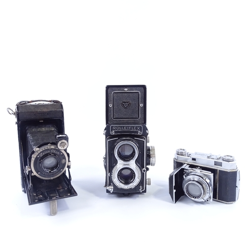 165 - Rolleiflex Twin Lens Reflex camera, a Kodak Retina II roll film camera, and a Zeiss Ikonta folding c... 