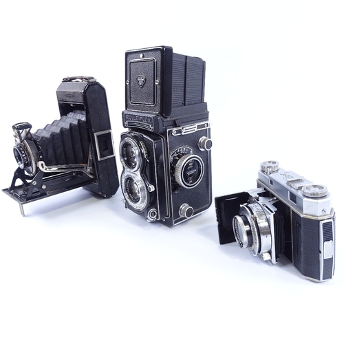 165 - Rolleiflex Twin Lens Reflex camera, a Kodak Retina II roll film camera, and a Zeiss Ikonta folding c... 