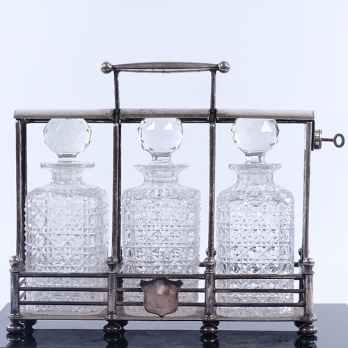 168 - A Victorian electroplate 3 bottle tantalus, by Olliant & Botsford circa 1880, length 34cm.