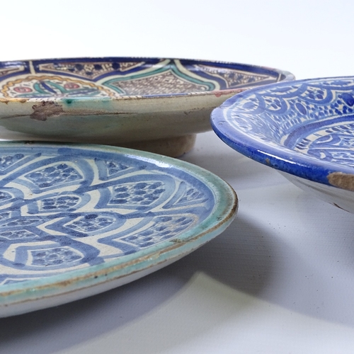 176 - 3 Middle Eastern majolica dishes, two signed on base, largest diameter 29cm.