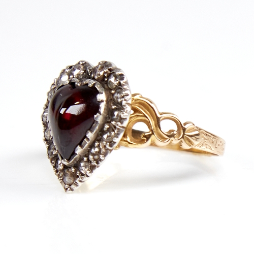 1103 - A Georgian unmarked gold heart-shaped cabochon garnet and rose-cut diamond cluster ring, pierced scr... 