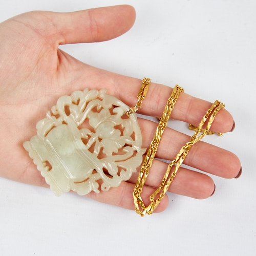 1106 - A Chinese carved and pierced jade basket of flowers pendant necklace, on a Chinese high carat gold f... 