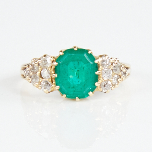 1110 - An early 20th century unmarked gold emerald and diamond cluster ring, set with octagonal step-cut em... 