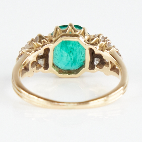 1110 - An early 20th century unmarked gold emerald and diamond cluster ring, set with octagonal step-cut em... 