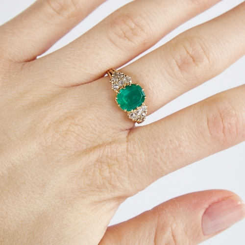 1110 - An early 20th century unmarked gold emerald and diamond cluster ring, set with octagonal step-cut em... 