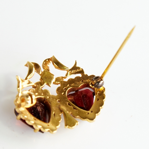 1120 - A late 20th century 9ct gold garnet and split pearl double-heart brooch, with ribbon surround, maker... 