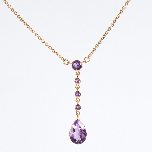 1131 - An Edwardian style 9ct gold amethyst line drop pendant necklace, set with round and pear-cut amethys... 