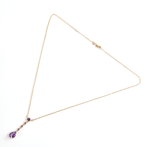 1131 - An Edwardian style 9ct gold amethyst line drop pendant necklace, set with round and pear-cut amethys... 