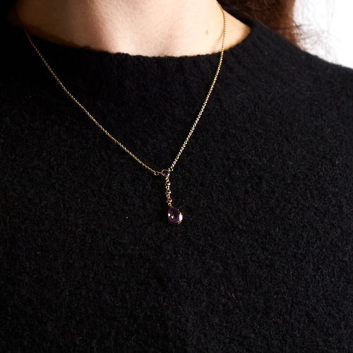 1131 - An Edwardian style 9ct gold amethyst line drop pendant necklace, set with round and pear-cut amethys... 