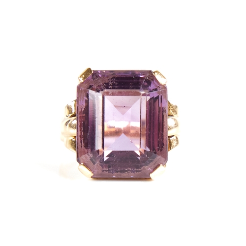 1132 - A large late 20th century 9ct gold step-cut amethyst ring, openwork lozenge bridge with raised shoul... 