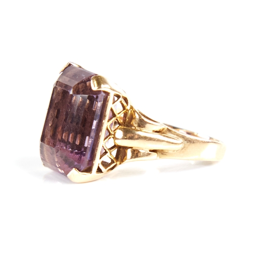 1132 - A large late 20th century 9ct gold step-cut amethyst ring, openwork lozenge bridge with raised shoul... 