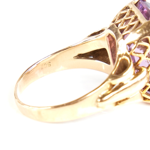 1132 - A large late 20th century 9ct gold step-cut amethyst ring, openwork lozenge bridge with raised shoul... 