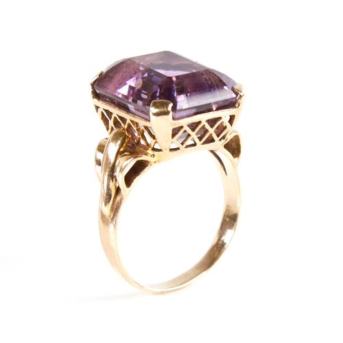 1132 - A large late 20th century 9ct gold step-cut amethyst ring, openwork lozenge bridge with raised shoul... 