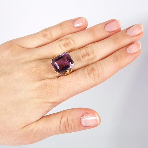 1132 - A large late 20th century 9ct gold step-cut amethyst ring, openwork lozenge bridge with raised shoul... 