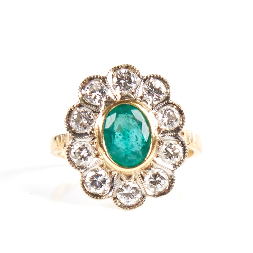 1133 - A Continental unmarked gold emerald and diamond cluster flowerhead ring, total diamond content appro... 