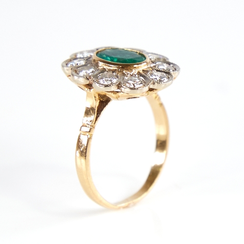 1133 - A Continental unmarked gold emerald and diamond cluster flowerhead ring, total diamond content appro... 