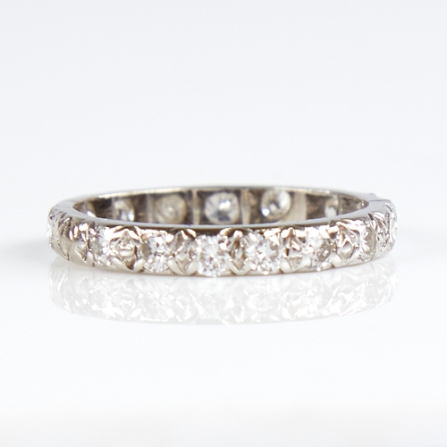 1139 - An unmarked white metal diamond eternity ring, total diamond content approx 0.8ct, band width 2.7mm,... 