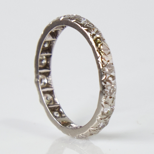 1139 - An unmarked white metal diamond eternity ring, total diamond content approx 0.8ct, band width 2.7mm,... 