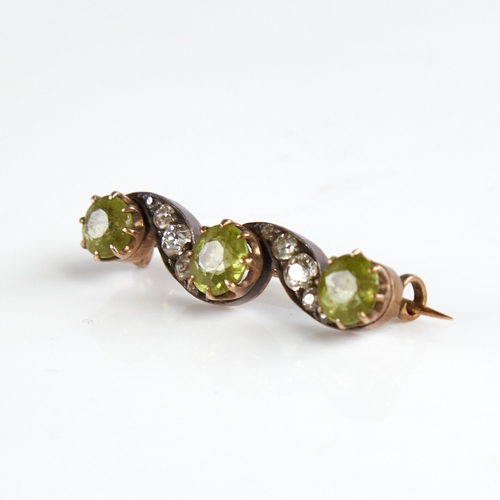 1146 - An early 20th century unmarked gold silver peridot and diamond brooch, total diamond content approx ... 