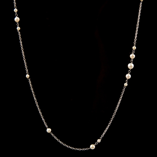 1149 - A long unmarked white gold pearl sautoir necklace, fine cable links with graduated pearl spacers, te... 