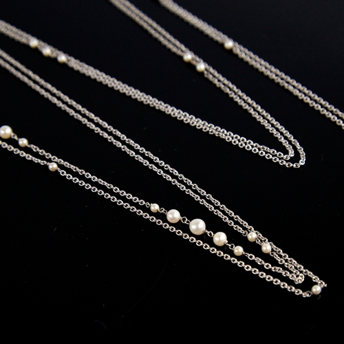 1149 - A long unmarked white gold pearl sautoir necklace, fine cable links with graduated pearl spacers, te... 