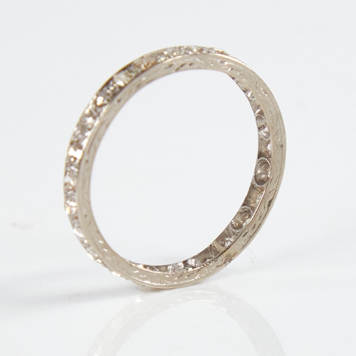 1158 - An early 20th century unmarked white metal diamond eternity ring, set with 26 round eight-cut diamon... 