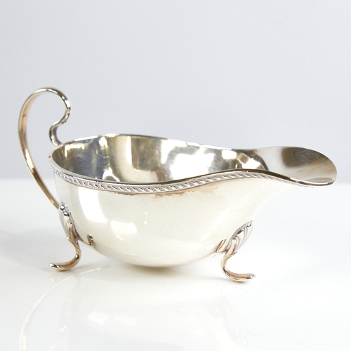 1161 - A George V silver sauce boat, gadrooned rim with scrolled acanthus leaf feet, by William Neale & Son... 