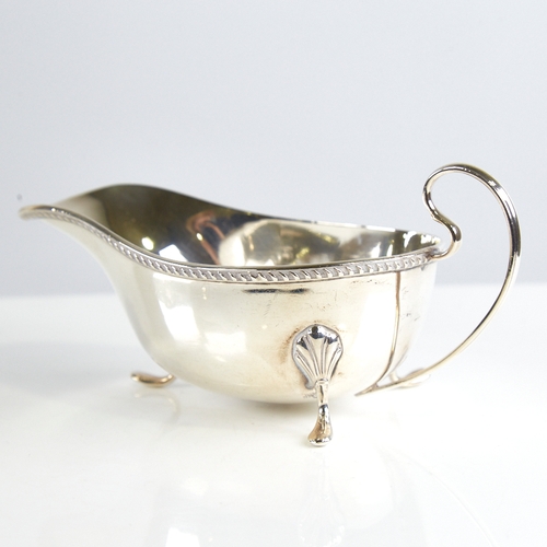 1161 - A George V silver sauce boat, gadrooned rim with scrolled acanthus leaf feet, by William Neale & Son... 