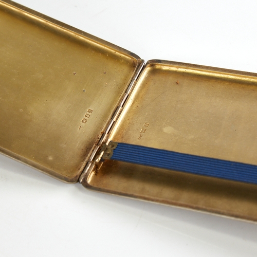 1163 - A George V rectangular silver cigarette case, allover engine turned decoration with gilt interior, i... 