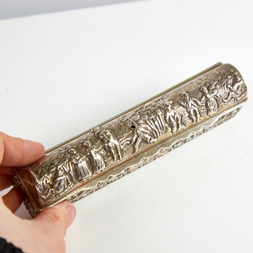 1165 - A George V silver dome-top dressing table box, long rectangular form with relief embossed decoration... 