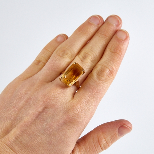 1168 - A late 20th century 14ct gold citrine dress ring, set with large emerald step-cut citrine, citrine l... 