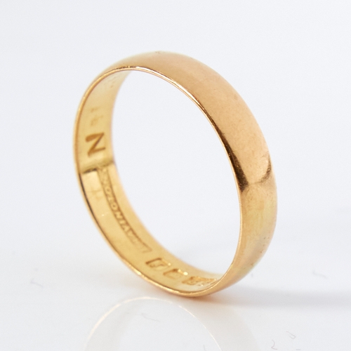 1169 - A mid-20th century 22ct gold wedding band ring, retailed by Bravingtons, hallmarks London 1964, band... 