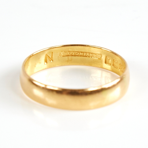 1169 - A mid-20th century 22ct gold wedding band ring, retailed by Bravingtons, hallmarks London 1964, band... 