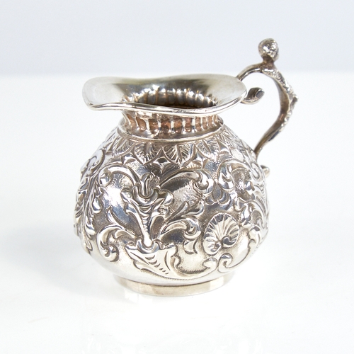 1174 - A Victorian silver squat cream jug, gourd form with relief embossed foliate decoration and figural h... 