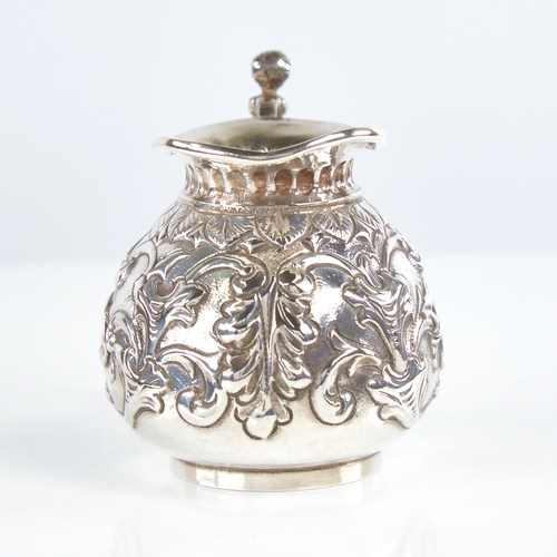 1174 - A Victorian silver squat cream jug, gourd form with relief embossed foliate decoration and figural h... 