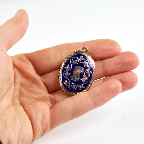 1175 - A Victorian unmarked gold and blue enamel locket pendant, engraved scroll and floral decoration, hei... 