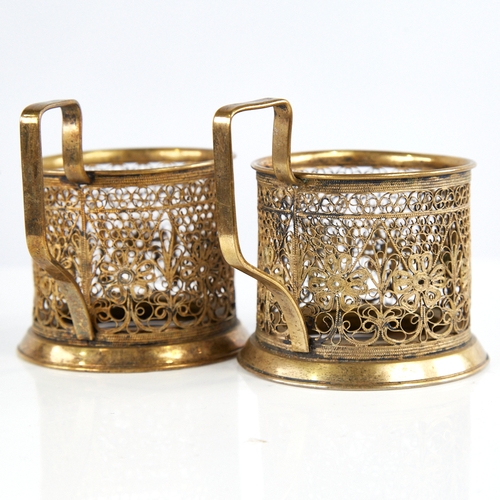 1179 - A pair of Russian unmarked gilt white metal tea glass holders, allover filigree wirework decoration,... 