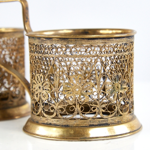 1179 - A pair of Russian unmarked gilt white metal tea glass holders, allover filigree wirework decoration,... 