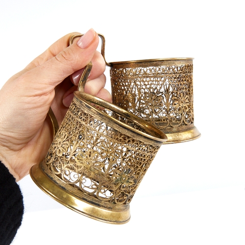 1179 - A pair of Russian unmarked gilt white metal tea glass holders, allover filigree wirework decoration,... 