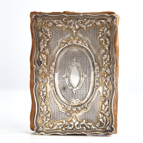 1185 - A 19th century Continental unmarked silver lady's notecase, allover relief embossed and engraved gra... 