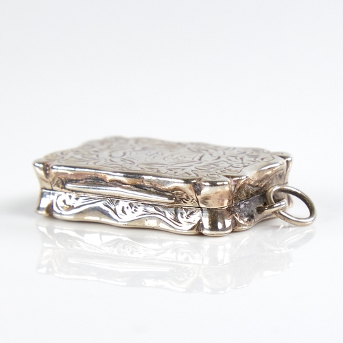 1190 - A Victorian silver vinaigrette, scalloped rectangular form with allover engraved floral decoration, ... 