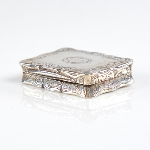 1192 - A Victorian silver vinaigrette, scalloped rectangular form with engine turned and engrave foliate de... 