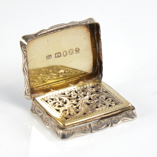 1192 - A Victorian silver vinaigrette, scalloped rectangular form with engine turned and engrave foliate de... 