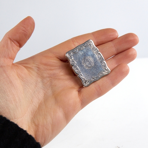 1192 - A Victorian silver vinaigrette, scalloped rectangular form with engine turned and engrave foliate de... 