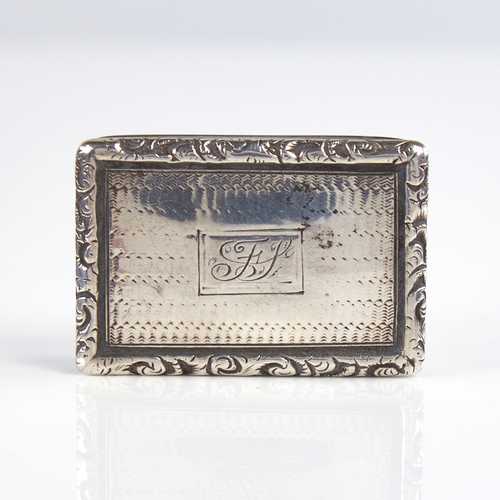 1193 - A William IV silver vinaigrette, rectangular form with cast floral border and engine turned decorati... 