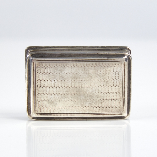 1193 - A William IV silver vinaigrette, rectangular form with cast floral border and engine turned decorati... 