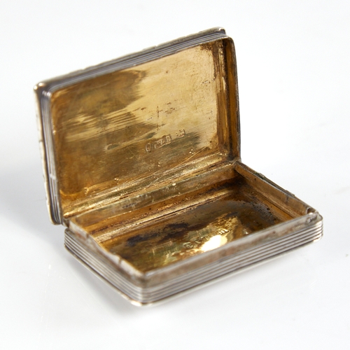 1193 - A William IV silver vinaigrette, rectangular form with cast floral border and engine turned decorati... 