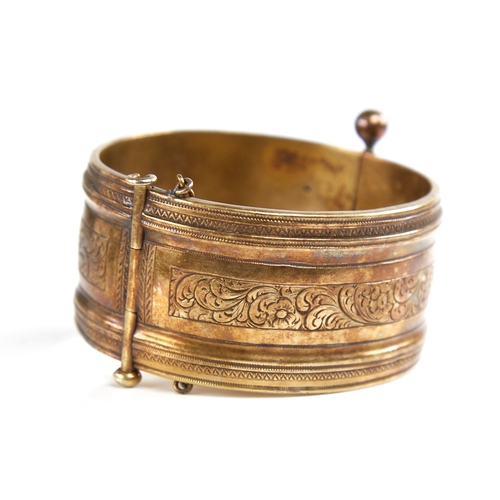 1201 - A 19th century unmarked silver? gilt hinged bangle, engraved floral panels, band width 32.7mm, inter... 